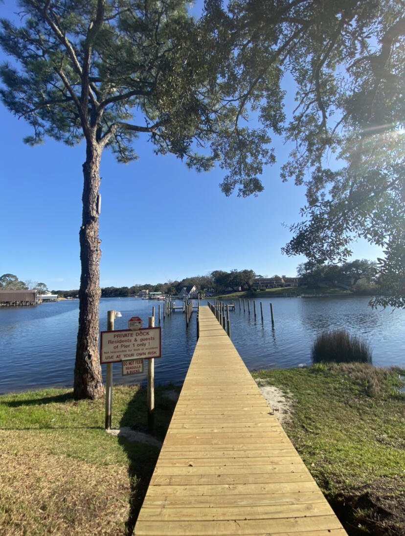 210 Pelham Road, Unit 213A Fort Walton Beach, FL 32547 - Photo 15 of 16 a view of a lake with a large trees