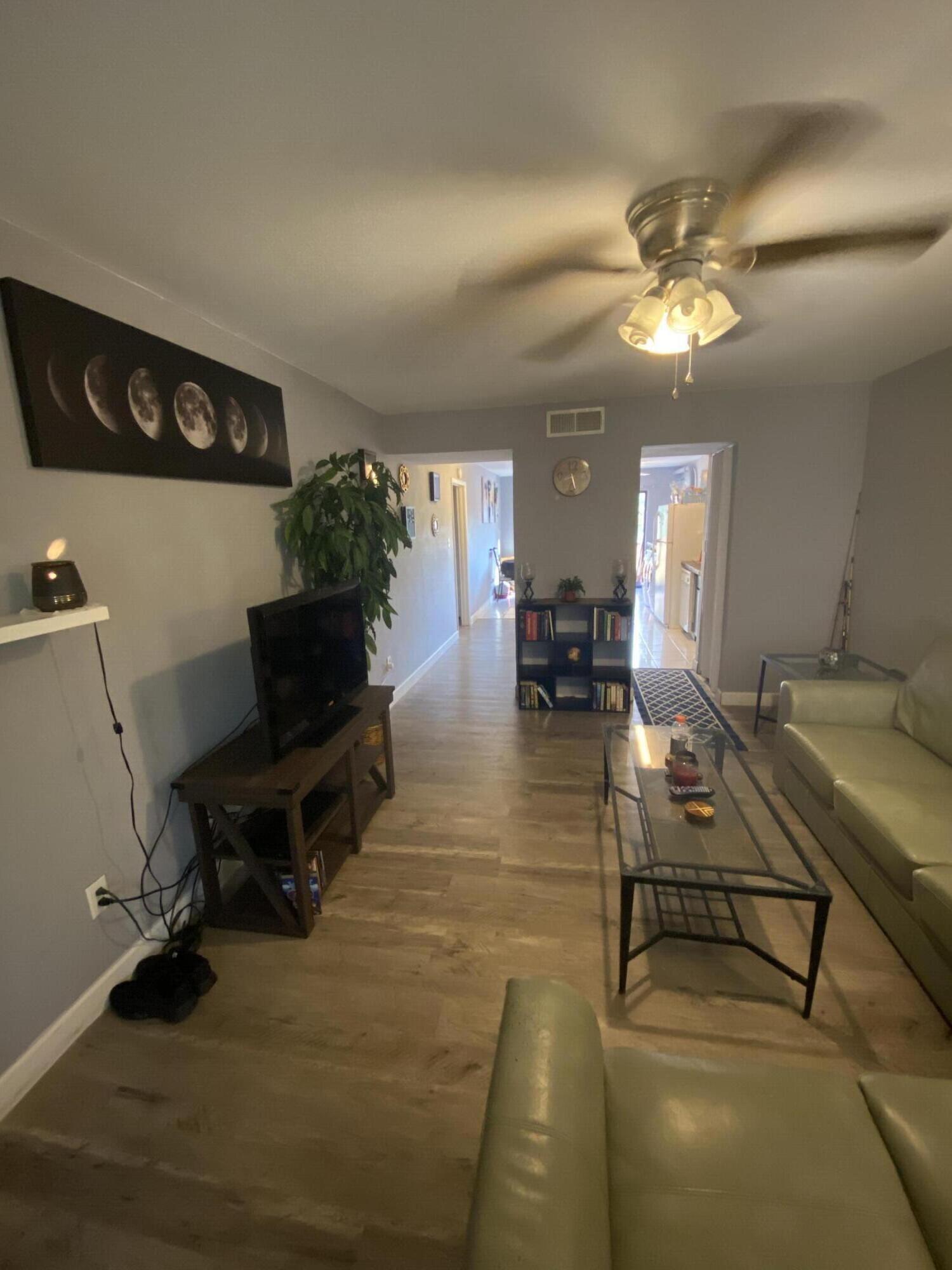 210 Pelham Road, Unit 213A Fort Walton Beach, FL 32547 - Photo 2 of 16 a view of a livingroom with furniture and a flat screen tv