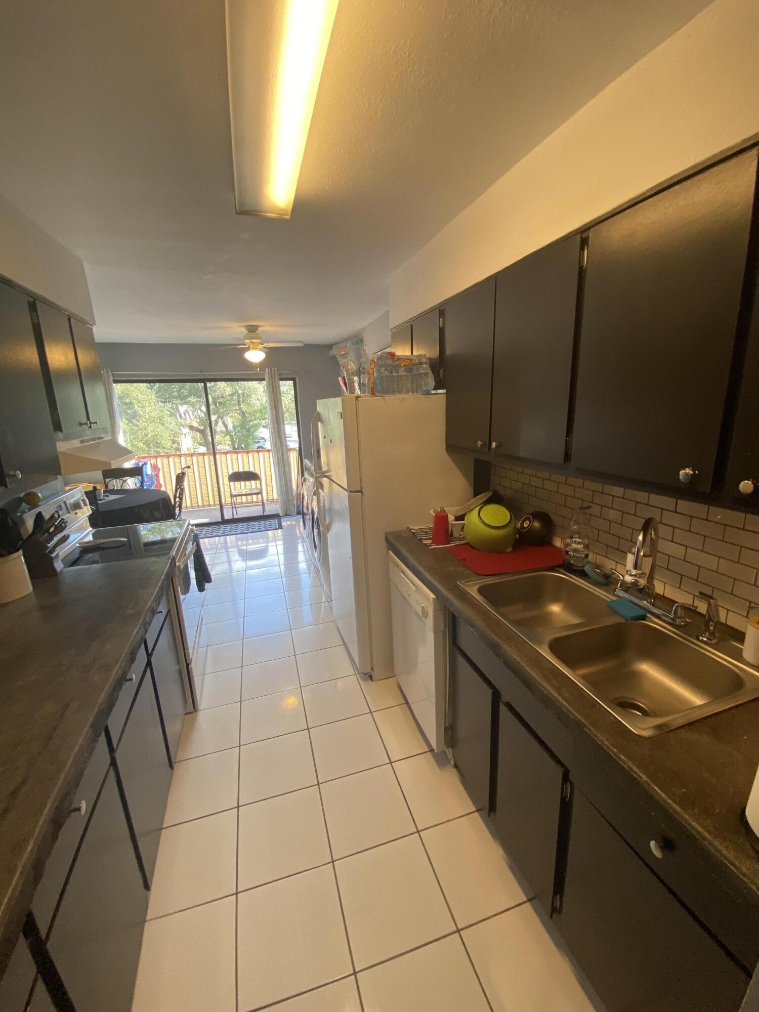 210 Pelham Road, Unit 213A Fort Walton Beach, FL 32547 - Photo 5 of 16 a kitchen with a sink and cabinets