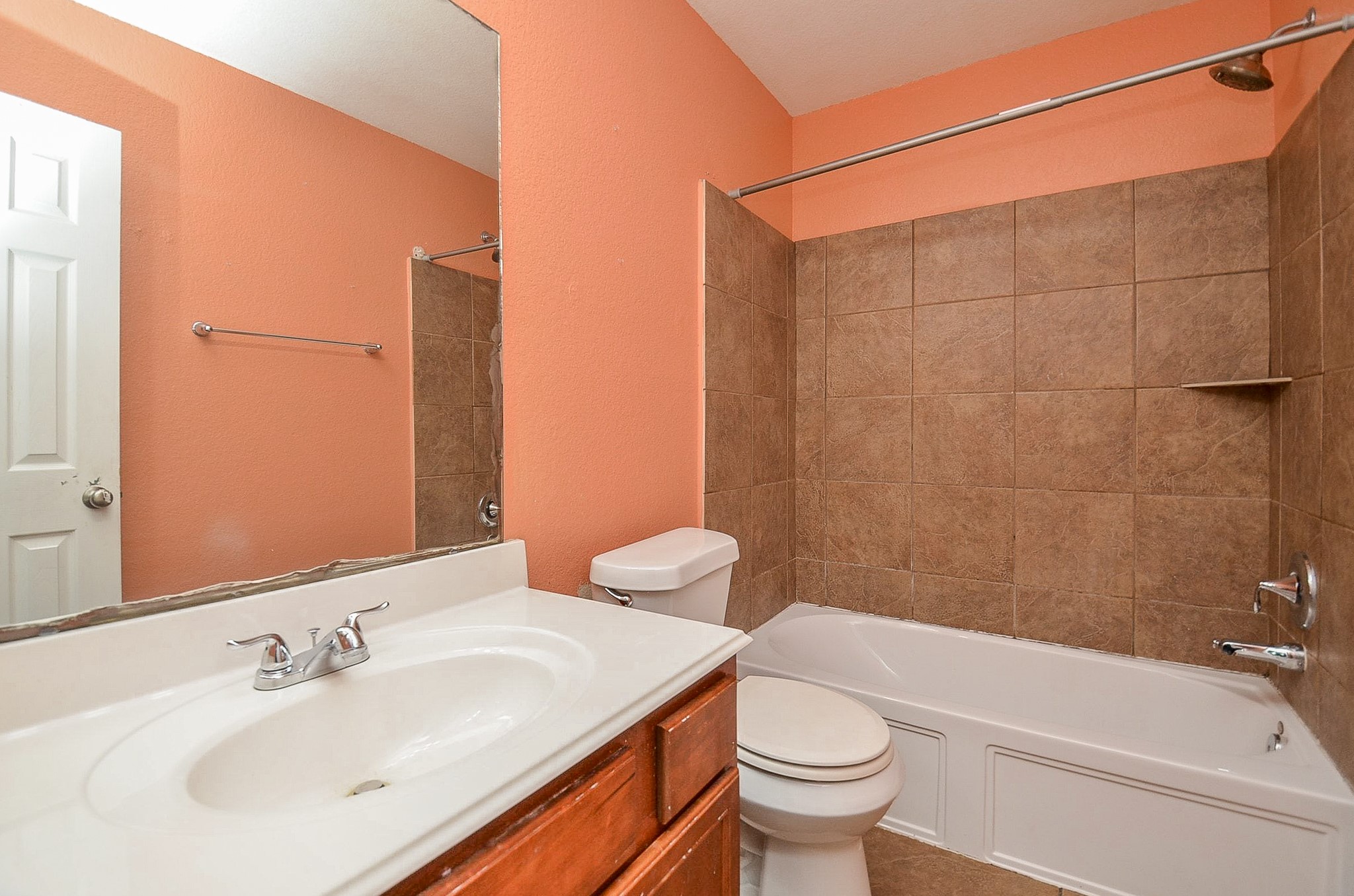 5411 Rio Drive Baytown, TX 77521 - Photo 17 of 30 With its neutral peach-toned walls and classic white fixtures, this bathroom is a versatile canvas ready for your personal touch.
