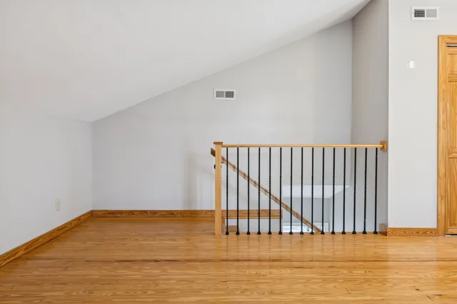 a view of a room with wooden floor