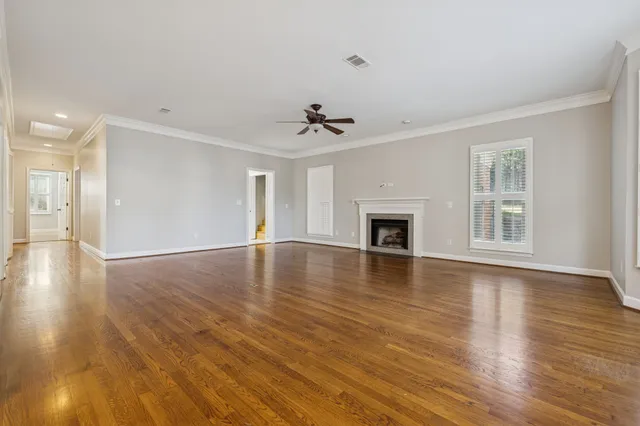 a view of a livingroom with wooden floor and a ceiling fan