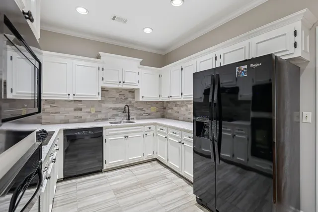 a kitchen with a refrigerator stove and sink