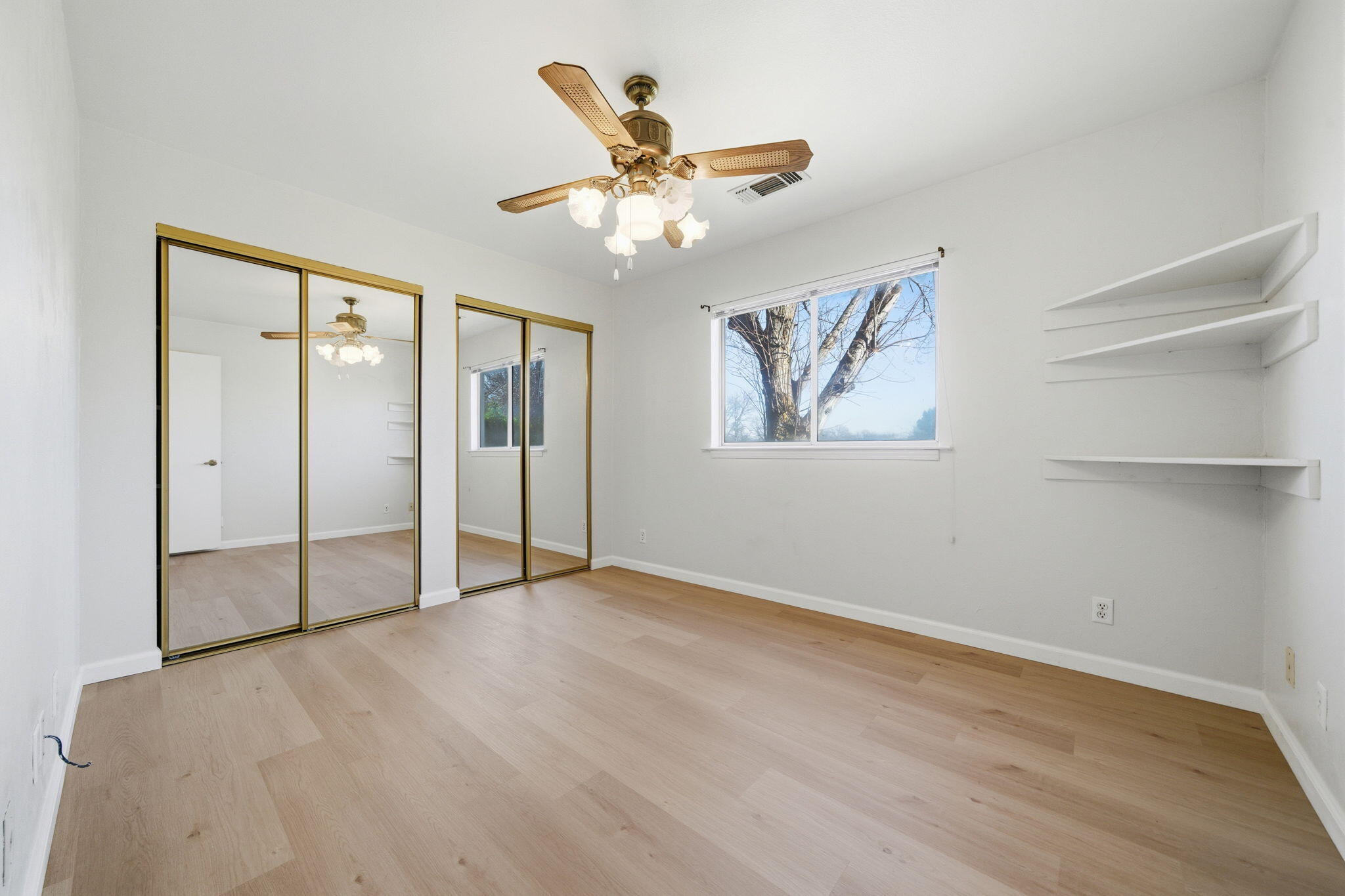 14435 Del Oro Court Red Bluff, CA 96080 - Photo 17 of 28 wooden floor in an empty room with a window