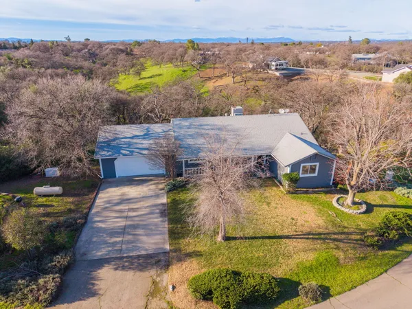 an aerial view of residential houses with outdoor space and swimming pool