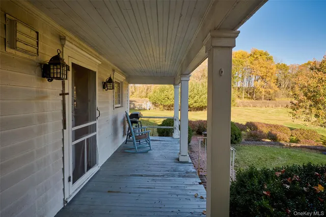 a view of a porch with wooden floor and outdoor space