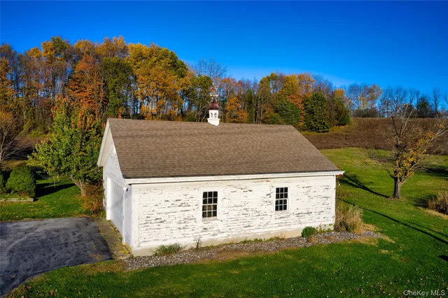 a view of house with backyard and trees