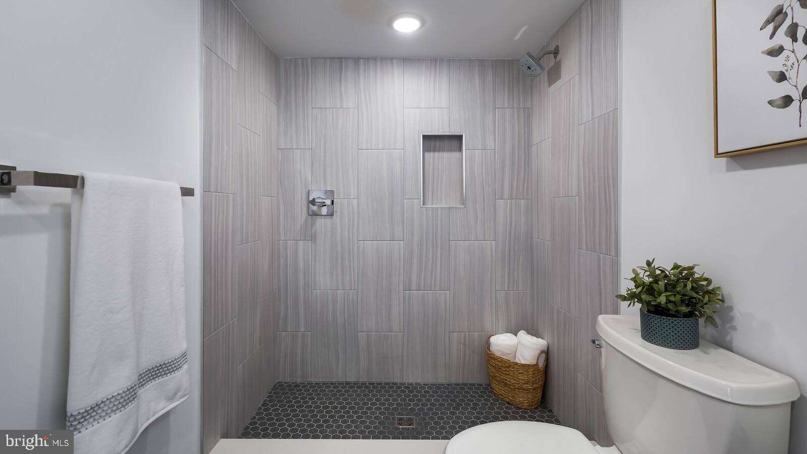 1825 Callowhill Street, Unit 311 Philadelphia, PA 19130 - Photo 17 of 50 a bathroom with a toilet and a shower curtain