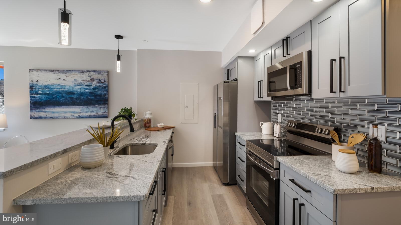 1825 Callowhill Street, Unit 311 Philadelphia, PA 19130 - Photo 3 of 50 a kitchen with stainless steel appliances granite countertop a sink stove and refrigerator