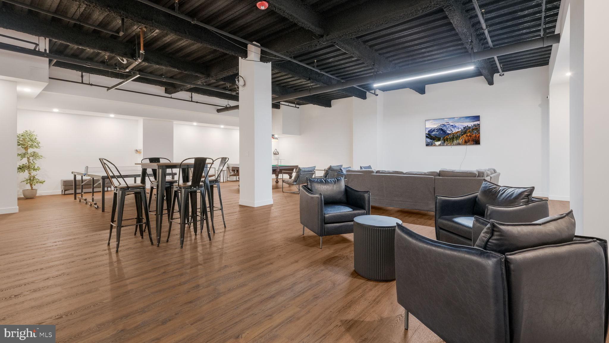 1825 Callowhill Street, Unit 311 Philadelphia, PA 19130 - Photo 44 of 50 a living room with lots of furniture and kitchen view