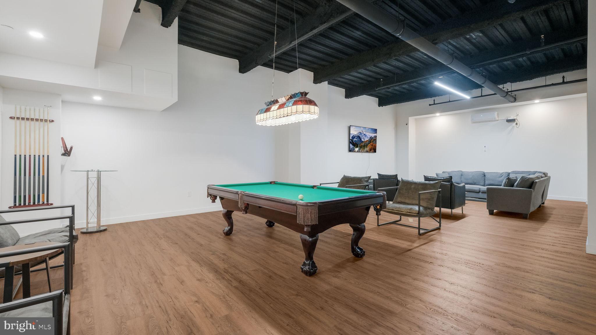 1825 Callowhill Street, Unit 311 Philadelphia, PA 19130 - Photo 45 of 50 a living room with furniture a rug and a chandelier