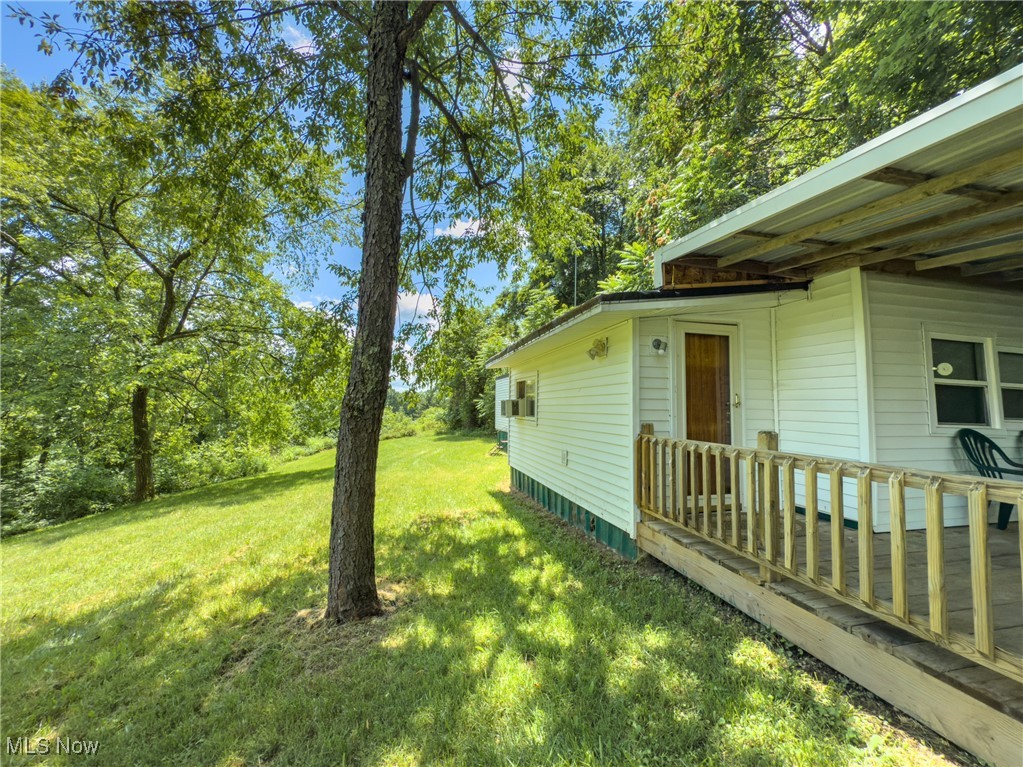 36475 Kinney Ridge Road Woodsfield, OH 43793 - Photo 27 of 50 View of green lawn featuring a deck
