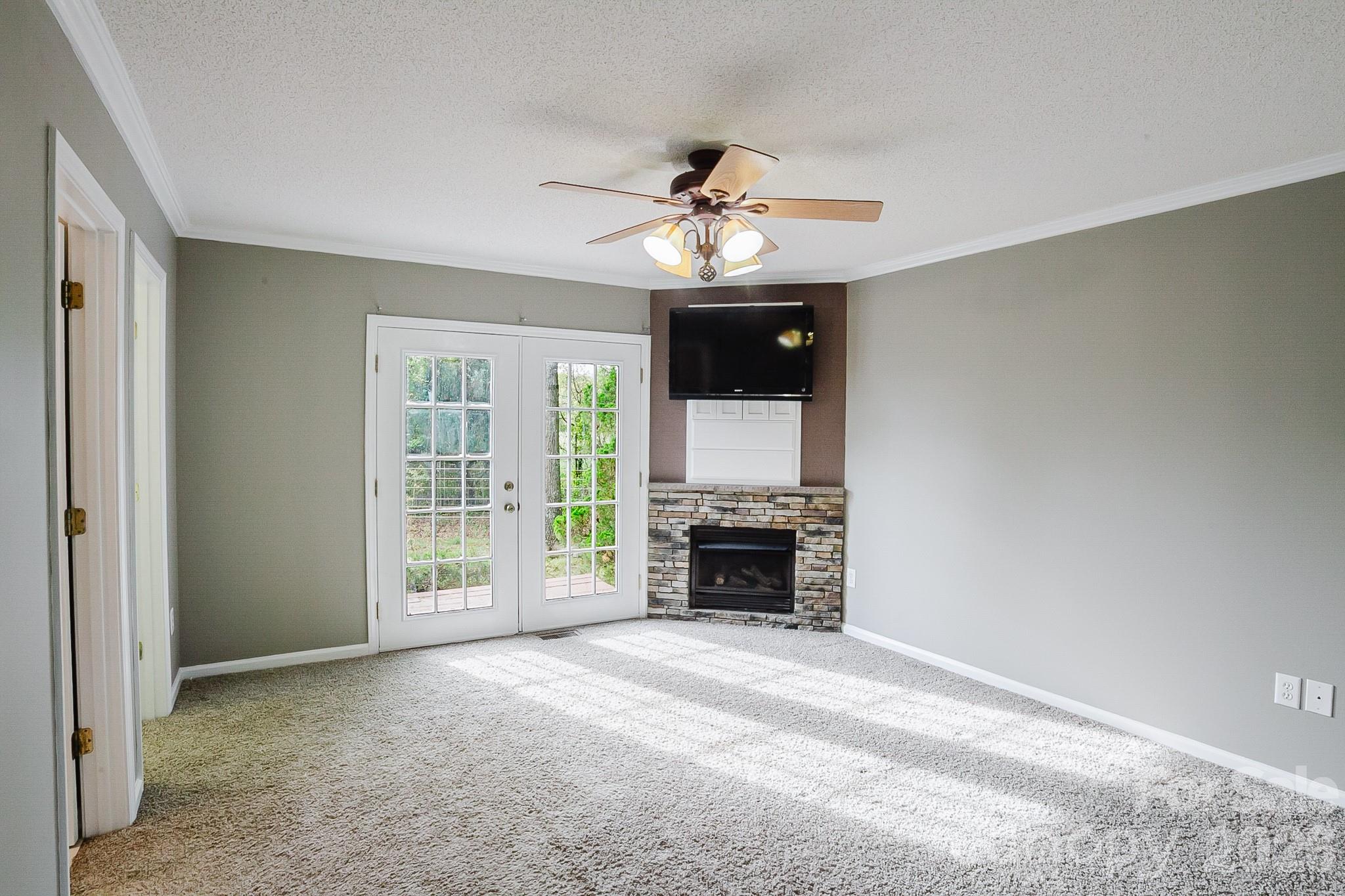 2104 Badin Road Albemarle, NC 28001 - Photo 14 of 46 a view of an empty room with a fireplace and a window