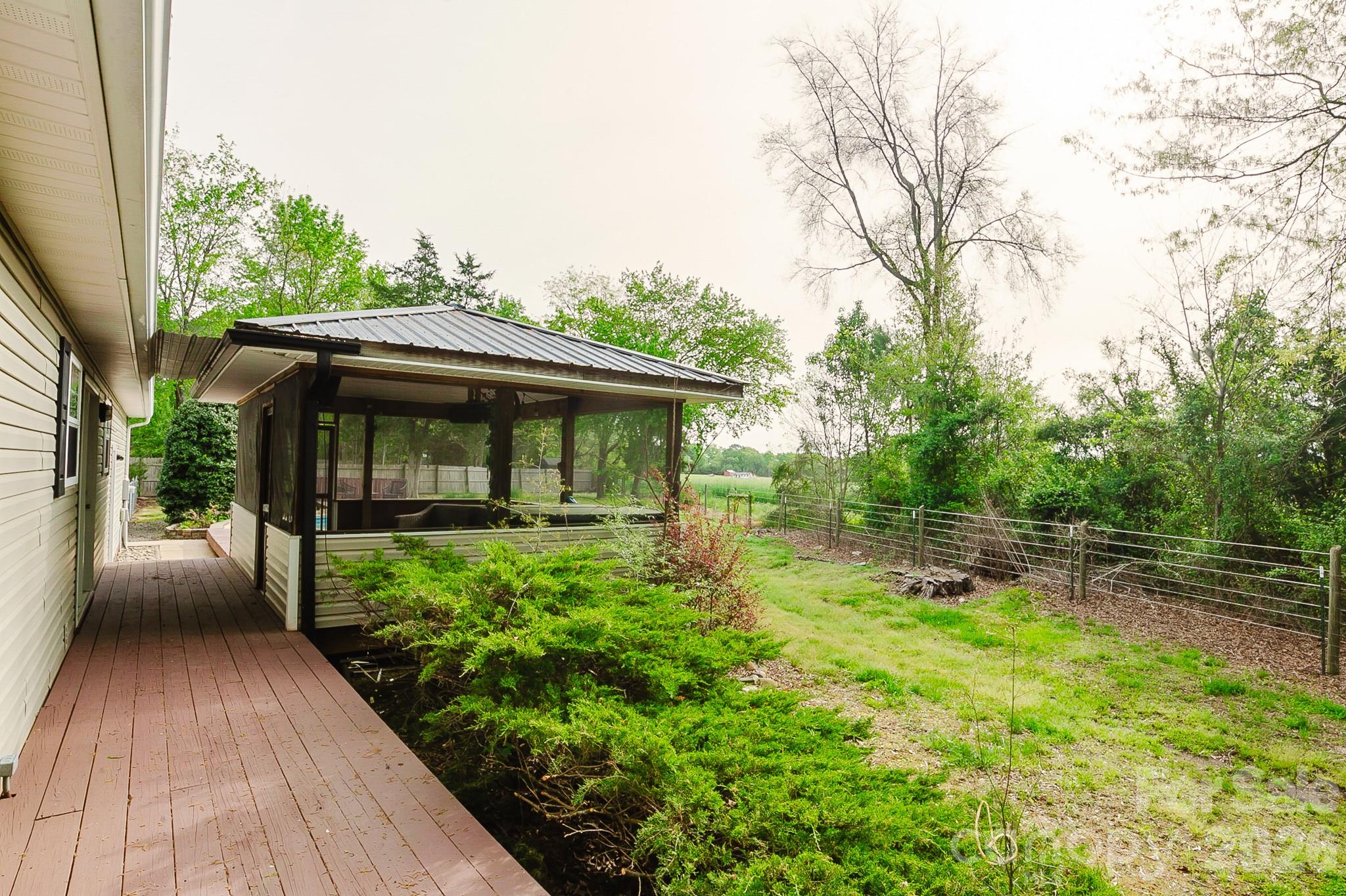 2104 Badin Road Albemarle, NC 28001 - Photo 27 of 46 a view of backyard with table and chairs and wooden fence