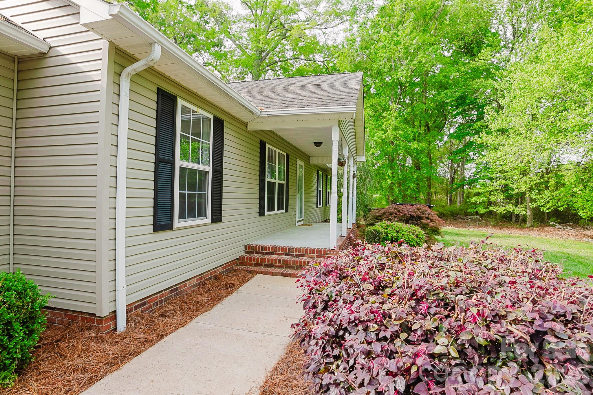 2104 Badin Road Albemarle, NC 28001 - Photo 32 of 46 a front view of a house with a garden