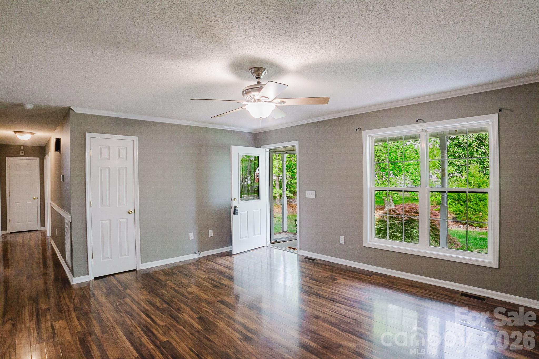 2104 Badin Road Albemarle, NC 28001 - Photo 5 of 46 a view of an empty room with wooden floor and a window
