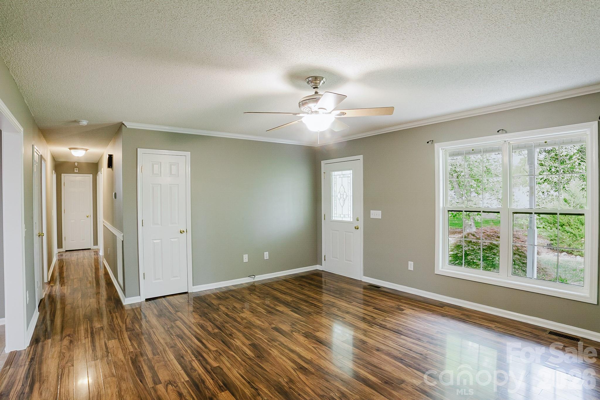 2104 Badin Road Albemarle, NC 28001 - Photo 6 of 46 a view of a room with wooden floor and a ceiling fan