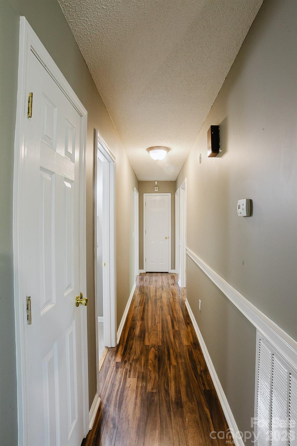 2104 Badin Road Albemarle, NC 28001 - Photo 8 of 46 a view of a hallway with wooden floor and staircase
