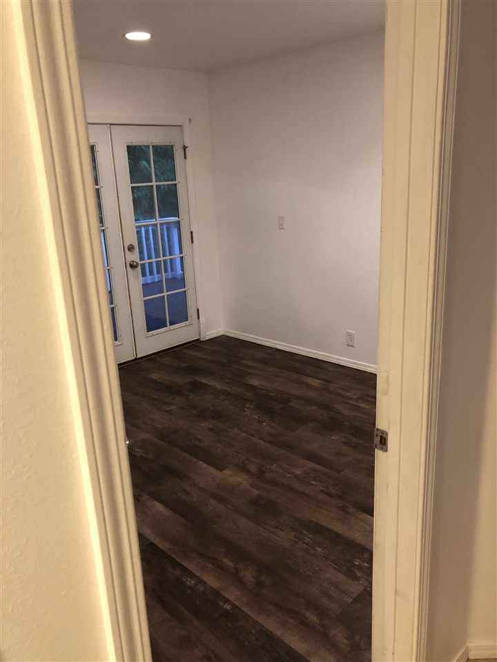 1565 Haiku Road, Unit 2 Haiku, HI 96708 - Photo 11 of 26 an empty room with wooden floor and a window