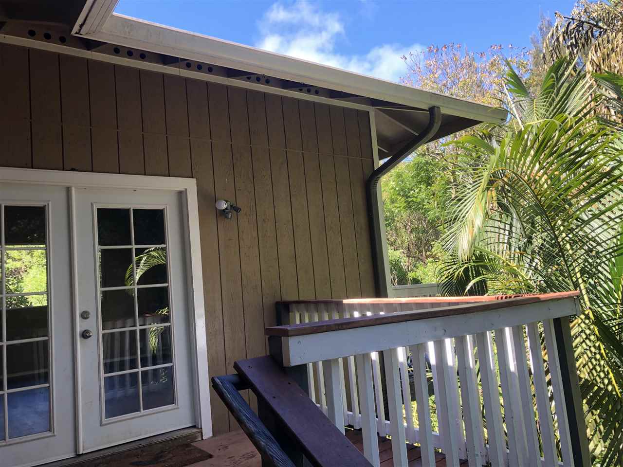 1565 Haiku Road, Unit 2 Haiku, HI 96708 - Photo 24 of 26 a view of a wooden door with a balcony