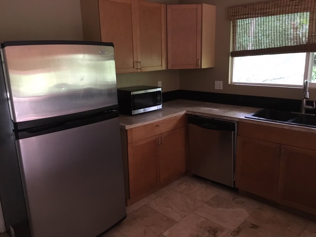 1565 Haiku Road, Unit 2 Haiku, HI 96708 - Photo 3 of 26 a kitchen with a sink and cabinets
