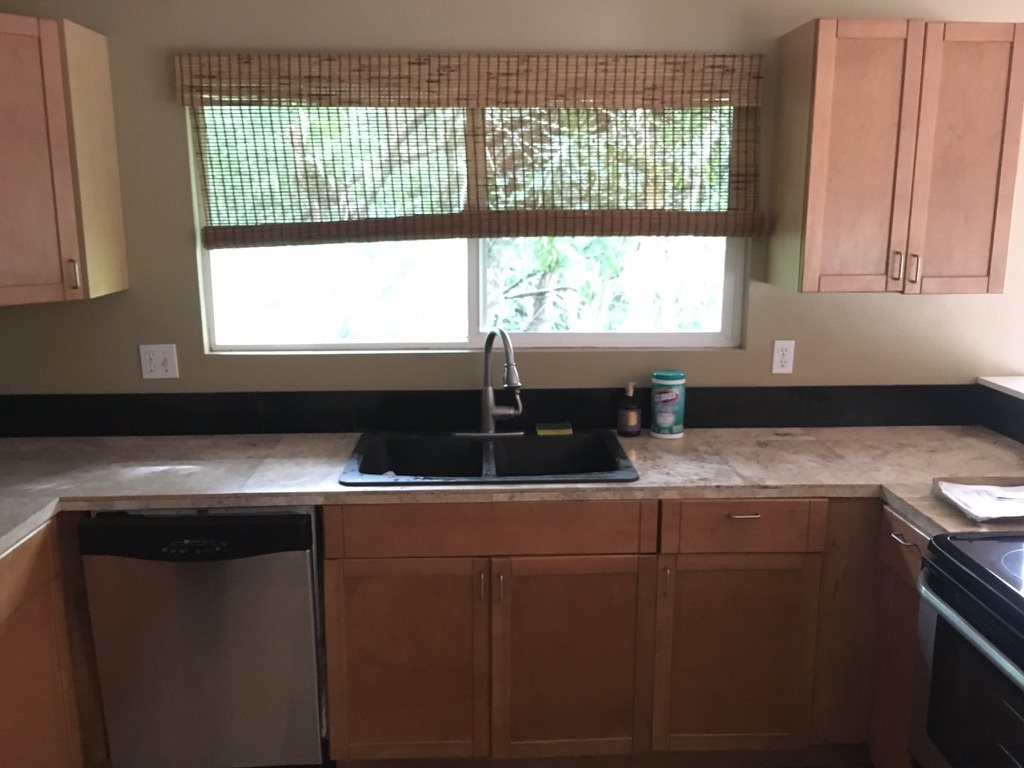 1565 Haiku Road, Unit 2 Haiku, HI 96708 - Photo 4 of 26 a kitchen with a sink a window and cabinets