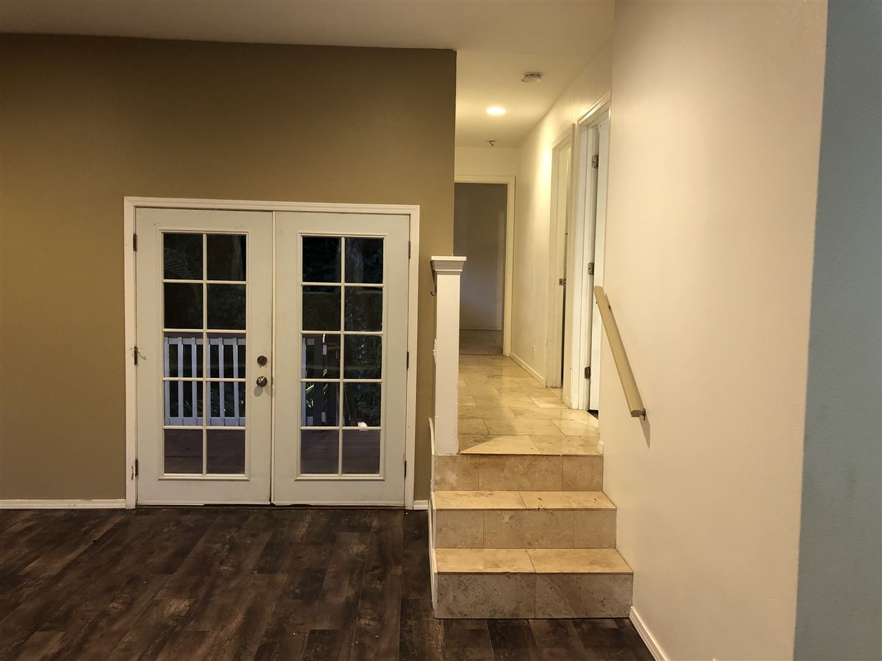 1565 Haiku Road, Unit 2 Haiku, HI 96708 - Photo 6 of 26 a view of staircase with wooden floor and windows