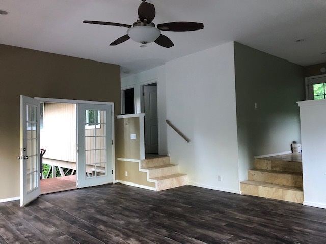1565 Haiku Road, Unit 2 Haiku, HI 96708 - Photo 8 of 26 a view of an empty room with wooden floor and a window
