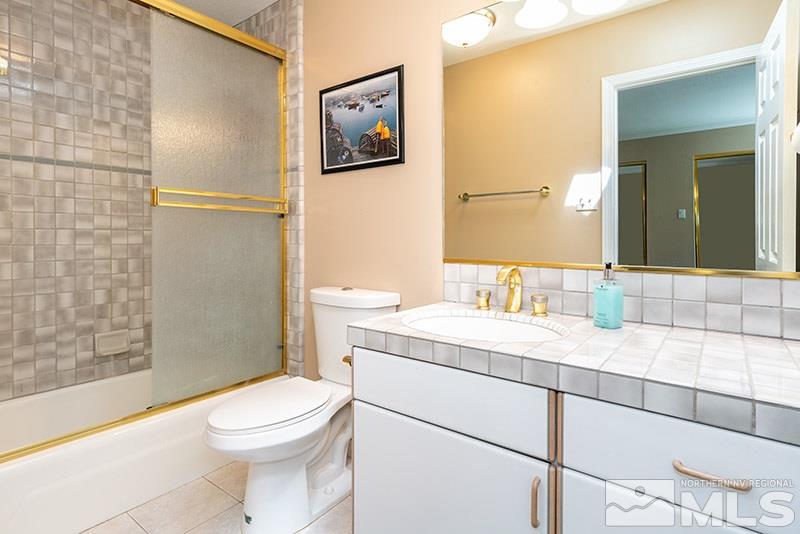 1344 Jones Street Reno, NV 89503 - Photo 20 of 24 a bathroom with a granite countertop toilet sink and a mirror