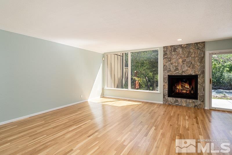 1344 Jones Street Reno, NV 89503 - Photo 3 of 24 a view of an empty room with wooden floor fireplace and a window