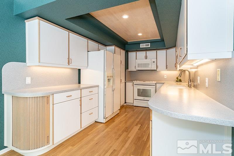 1344 Jones Street Reno, NV 89503 - Photo 8 of 24 a kitchen with white cabinets and white appliances