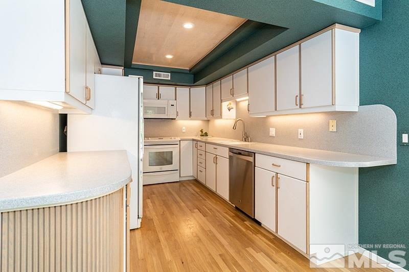 1344 Jones Street Reno, NV 89503 - Photo 9 of 24 a kitchen with cabinets a sink and white appliances