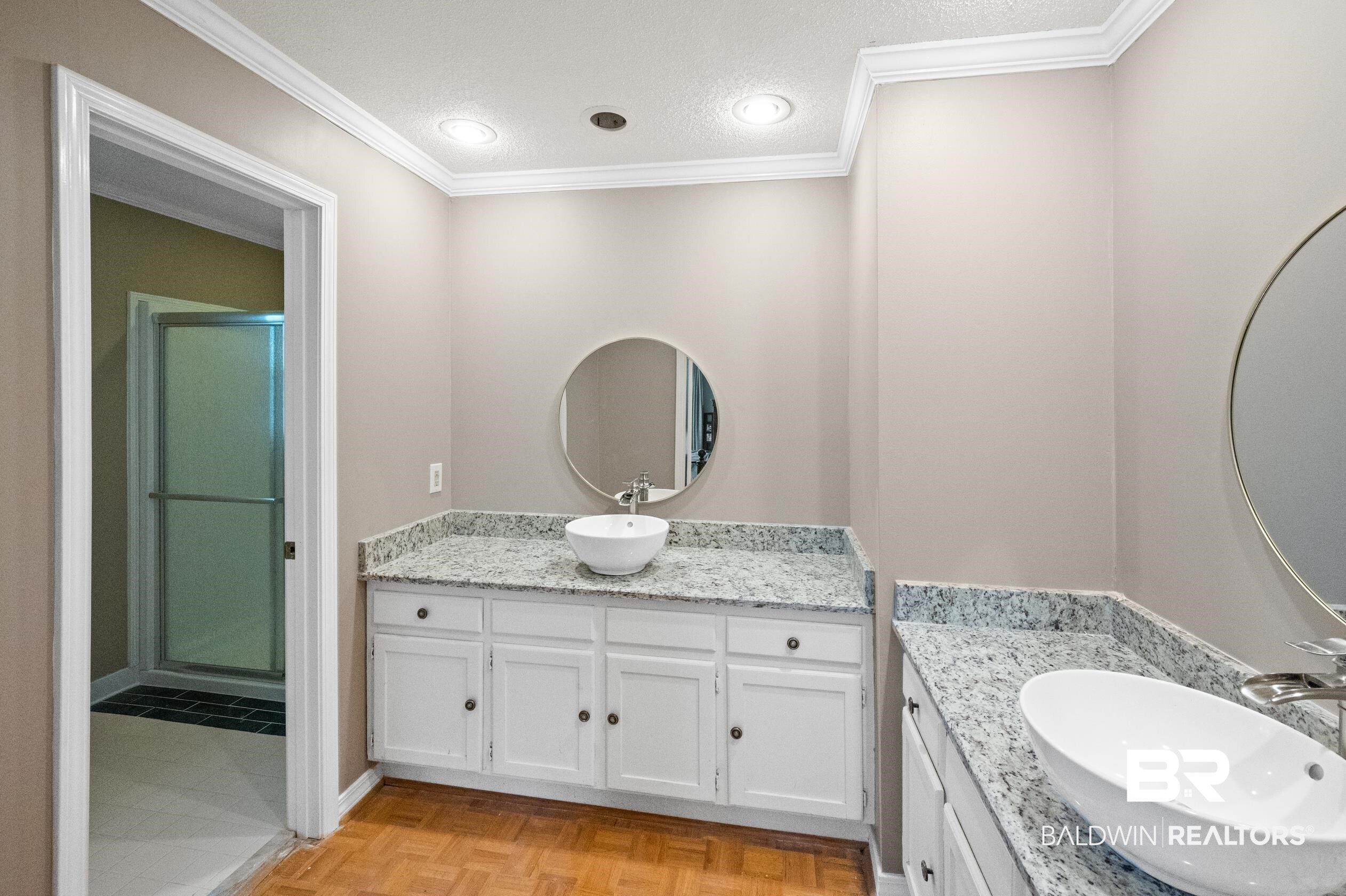 6705 Ridgeland Road South Mobile, AL 36695 - Photo 24 of 44 Bathroom with vanity, a textured ceiling, ornamental molding, and a shower with shower door