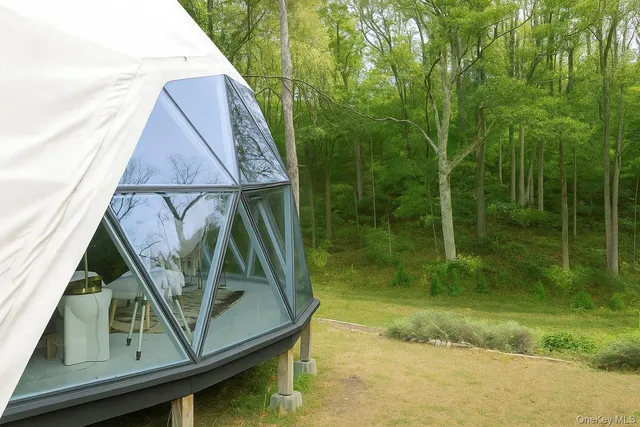 a backyard of a house with yard and outdoor seating
