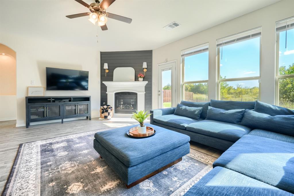 a living room with furniture a fireplace and a flat screen tv