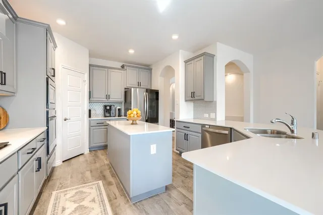 a kitchen that has a sink and a stove in it