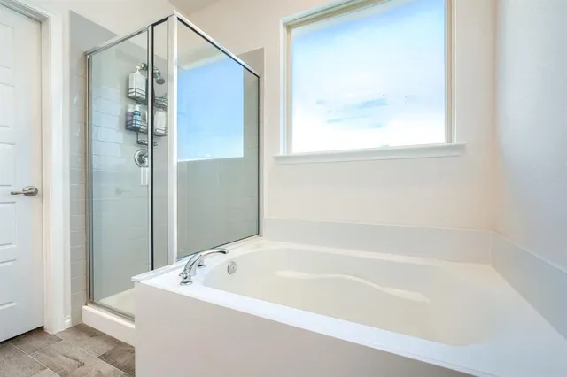 a white bath tub sitting next to a small window