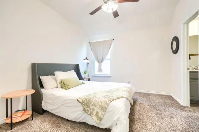 a bedroom with a bed and chandelier