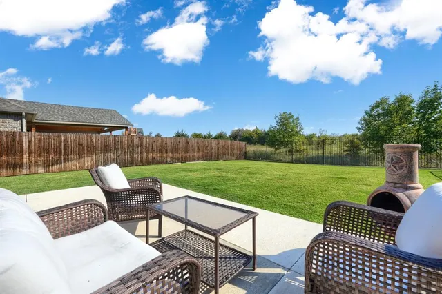 a view of a patio with couches chairs and a yard