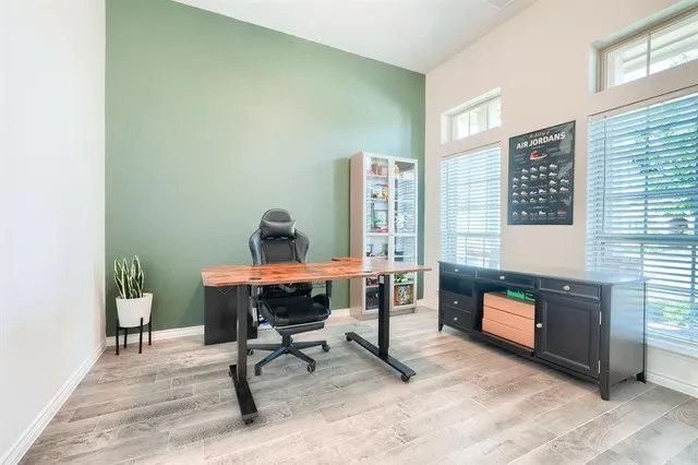 a view of a workspace with furniture and a window