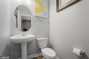 a bathroom with a toilet sink and mirror