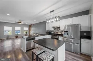 a kitchen with a stove a sink and a refrigerator