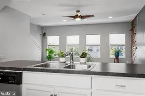 a kitchen with granite countertop a sink stainless steel appliances and cabinets
