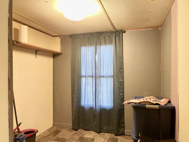 a bedroom with a bed and a table