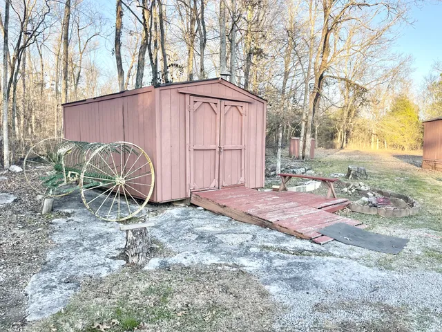 a backyard of a house with garden and barbeque oven
