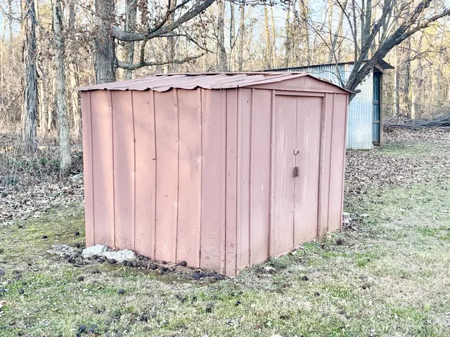 a view of a backyard with wooden fence