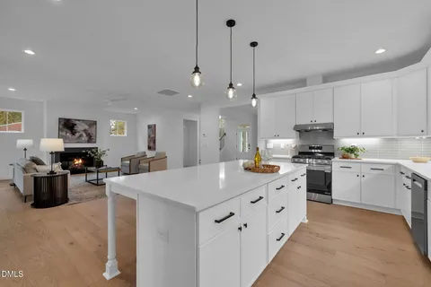 a view of staircase with wooden floor and white walls