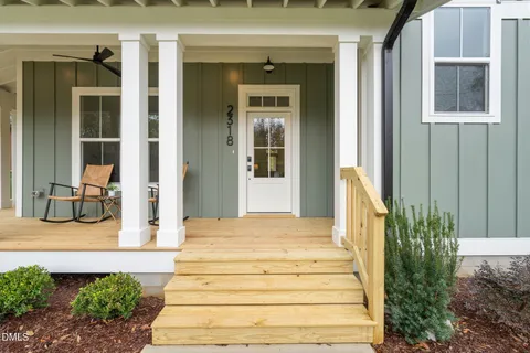 a balcony with table and chairs