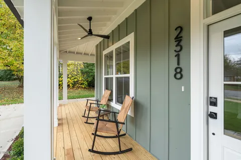 an aerial view of residential houses with outdoor space and trees