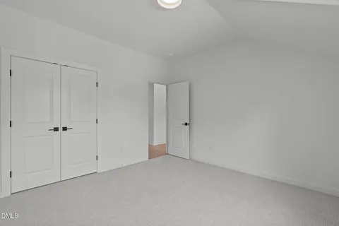 a balcony with wooden floor table and chairs